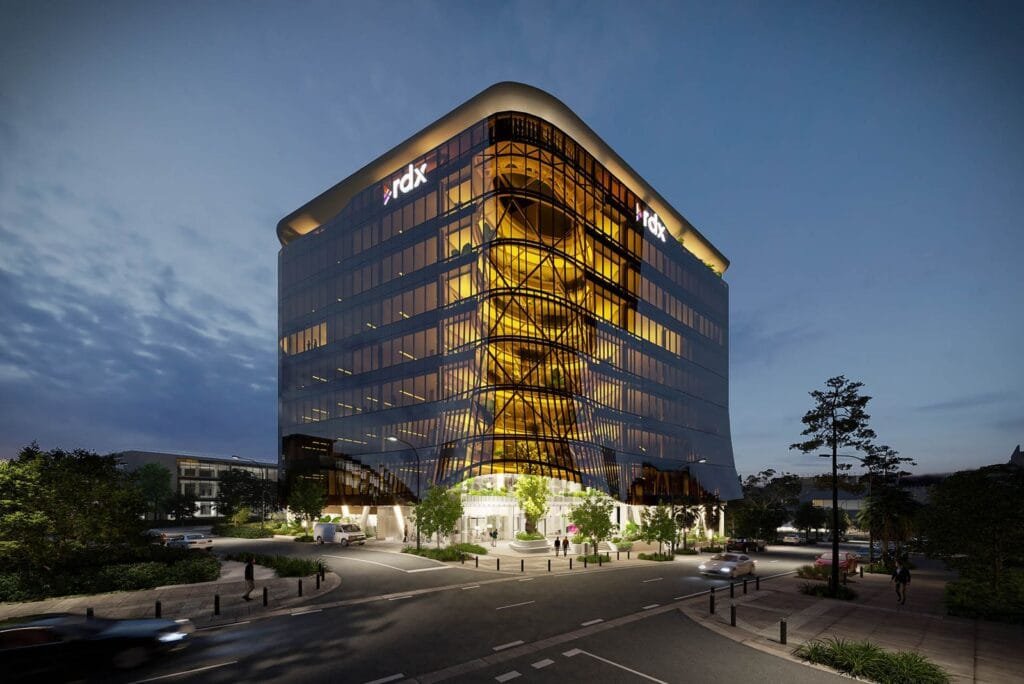 Architectural visualisation of RDX commercial office tower exterior at twilight with golden atrium lighting